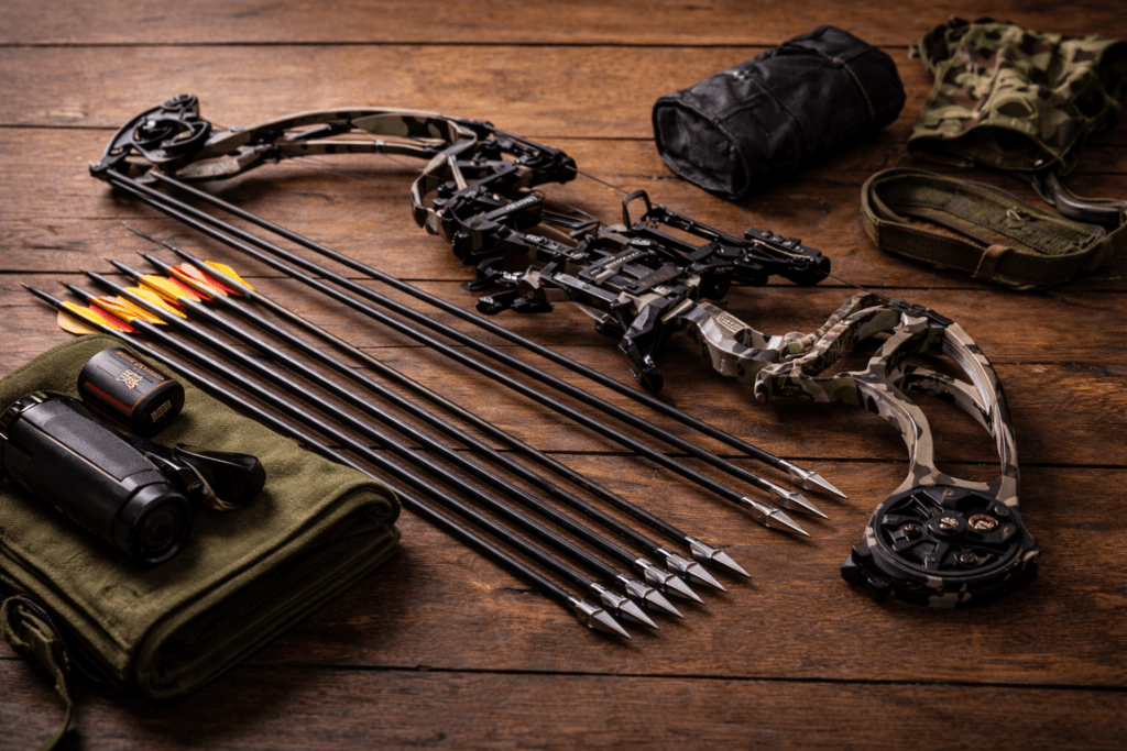 Oversigt over buejagtudstyr med compoundbue, pile, sigte og stabilisator lagt klar til jagt